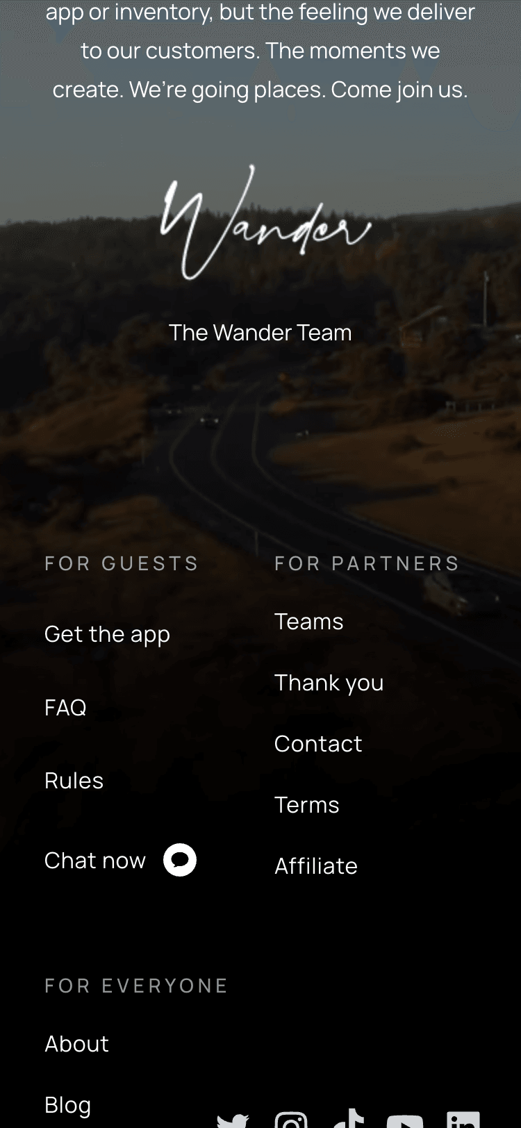 The footer of the Wander homepage on a mobile device. Above the footer is a message from the Wander team that ends with a handwritten signature saying 'Wander.'